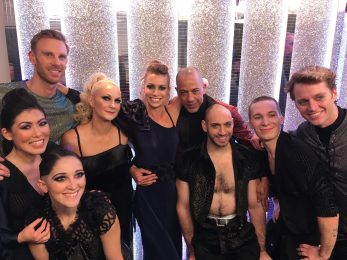 Candoco dancers and Trent Whiddon posing in front of the sparkly Strictly Come Dancing set