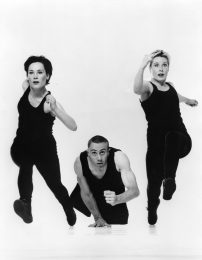 3 people move towards camera as if in a race
