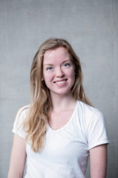 Paulina Porwollik. A headshot of a smiling person with long blonde hair wearing a white v necked tshirt