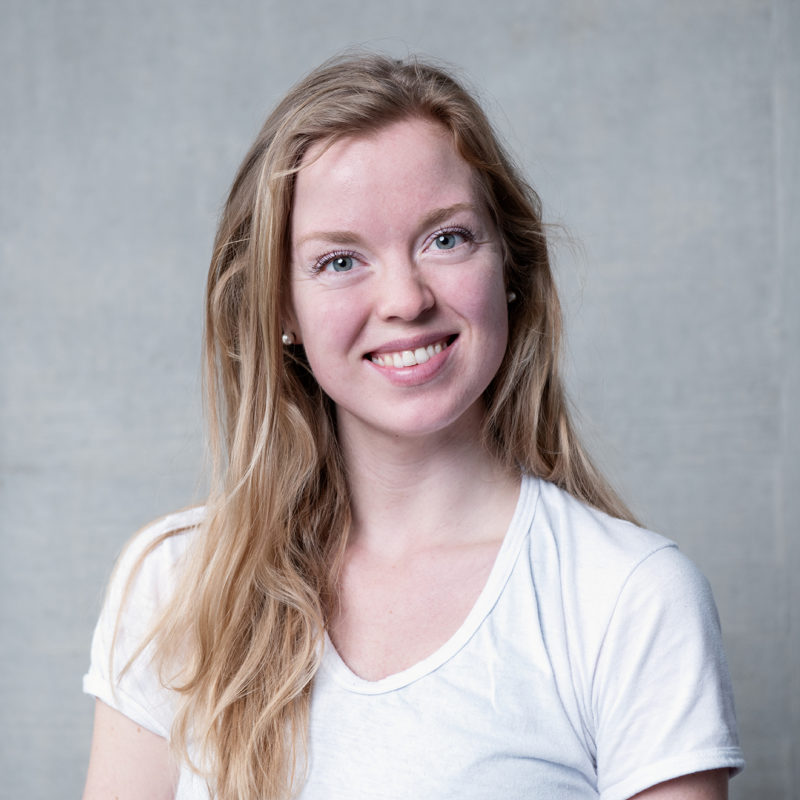 Paulina Porwollik. A headshot of a smiling person with long blonde hair wearing a white v necked tshirt